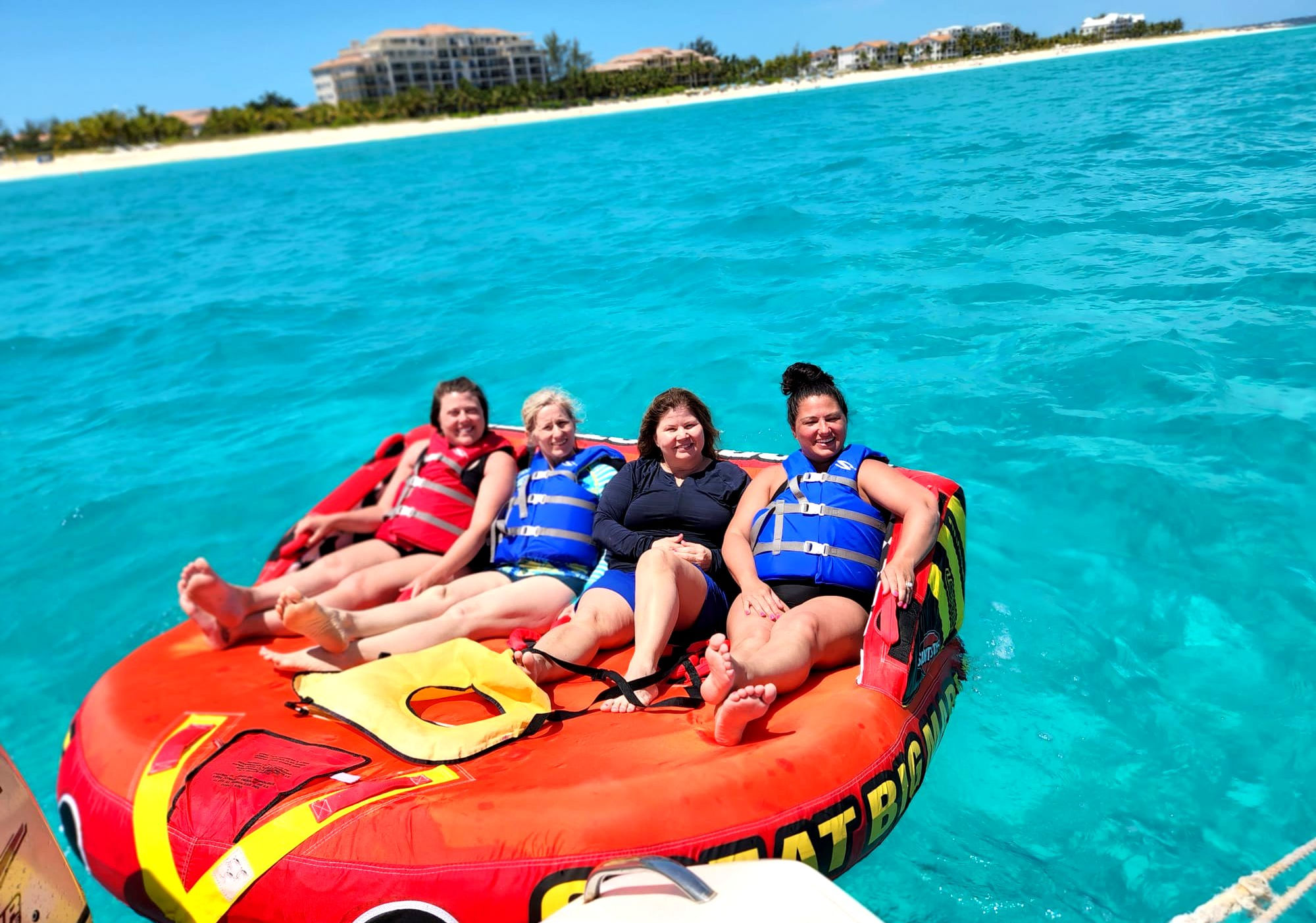 Guest sliding into the ocean from the One Love boat slide