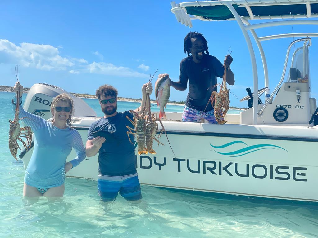 Guest sliding into the ocean from the One Love boat slide